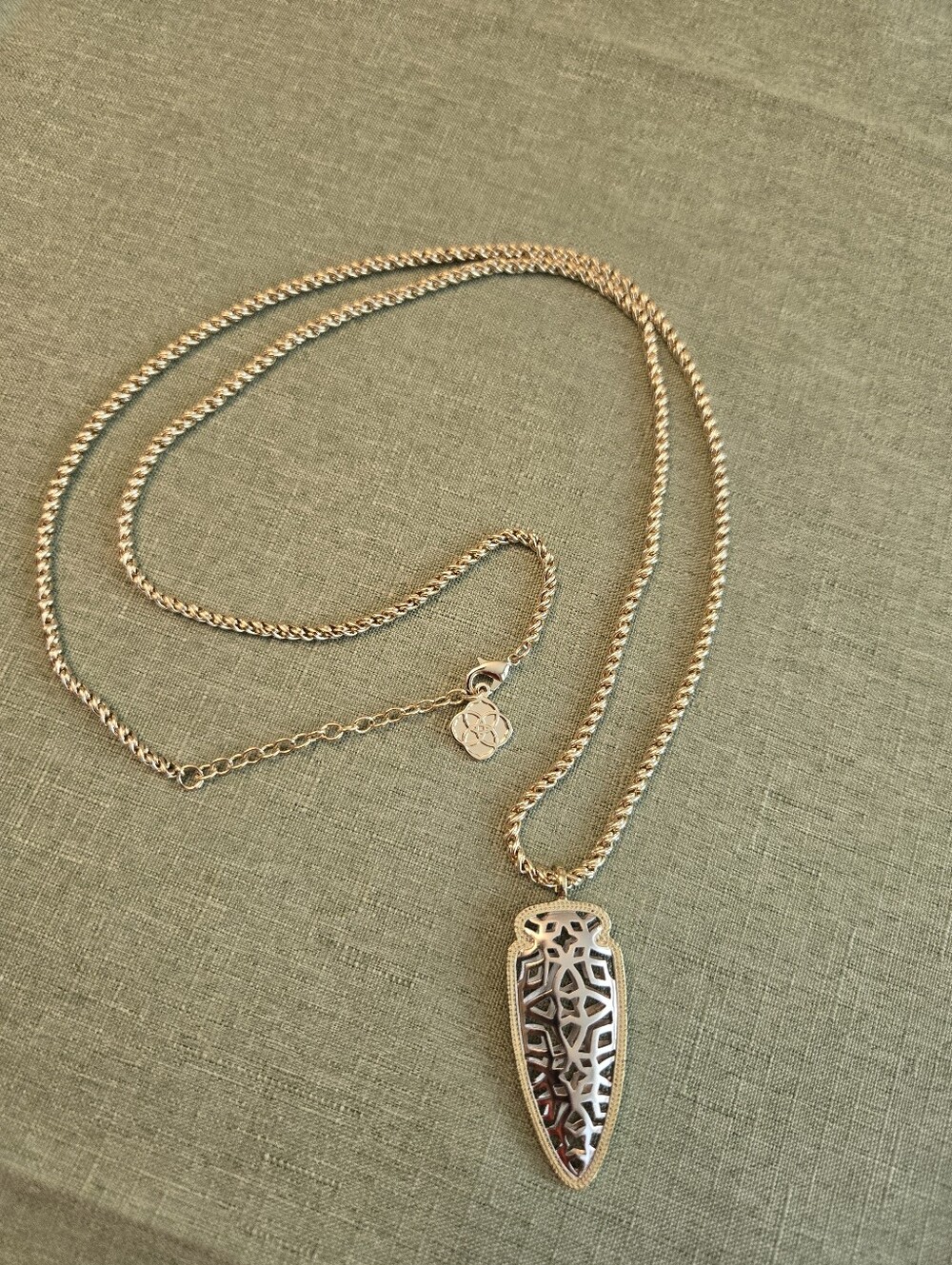 Kendra, Scott Sienna Long Arrowhead pendant. Gold and silver tone filigree.